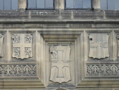 Detail of the facade showing (from left to right) the coats of arms of Van Mildert, the Prince Bishop who founded Durham University; the Bishopric of Durham, Durham University, the City of Durham. The coat of arms to the far right is yet to be identified.  